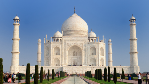 Lentini Visas | Immigration Services, Law Office of Jacqueline Lentini LLC | Mass Cancellations of H-1B Visa Appointments in India: What Applicants Should Know The Taj Mahal is a white marble building with a large dome and four tall towers. The structure features symmetrical Islamic architecture with intricate details.