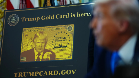 Lentini Visas | Immigration Services, Law Office of Jacqueline Lentini LLC | Trump Creates the Gold Card Program A large poster shows a gold card with bold text around it. Trump is seen blurred in the foreground.