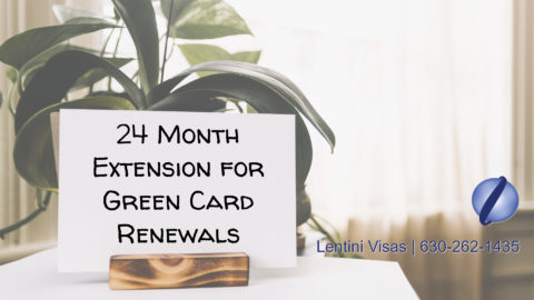 A stand with a sign that has text edited on top of the sign says, "24 Month Extension for Green Card Renewals." Lentini Visas, logo and phone number are on the right-hand side of the image. 